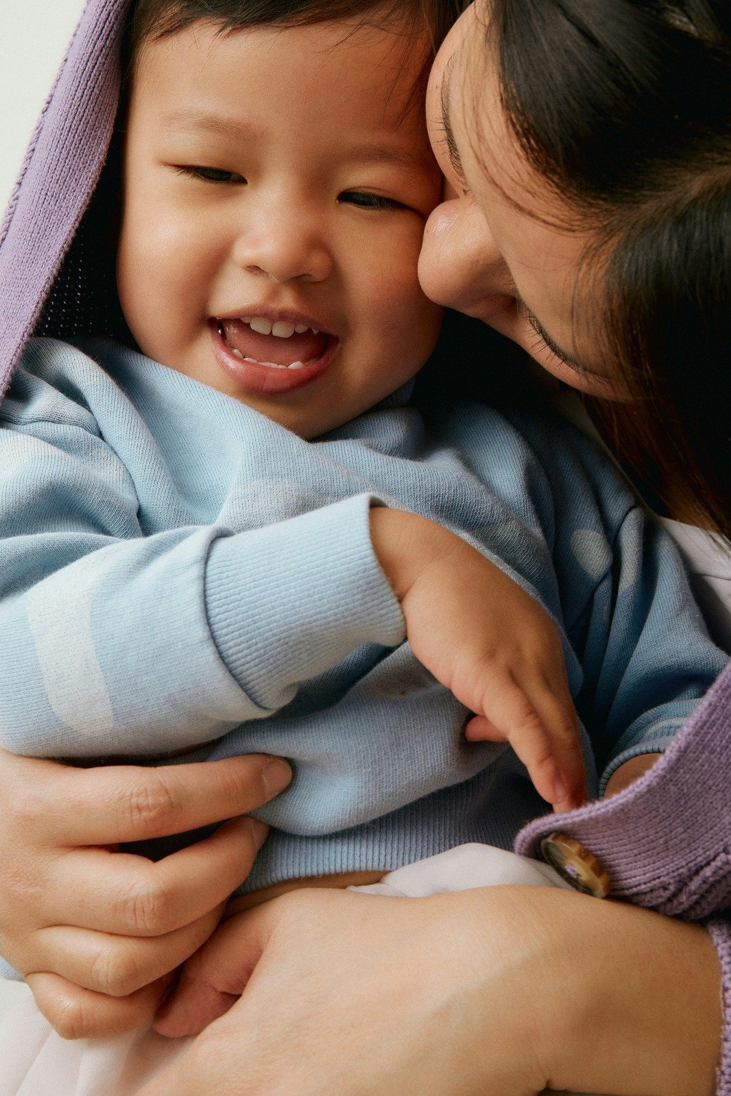 Parent pressing their forehead to a child